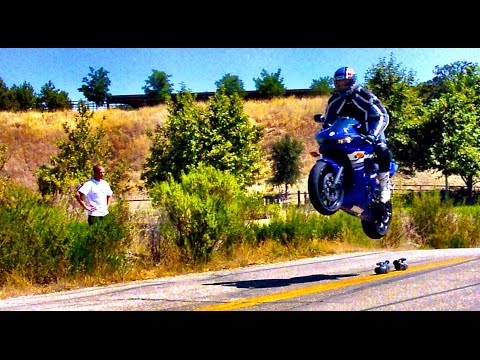 GSXR1000 goes off jump and lands doing a wheelie