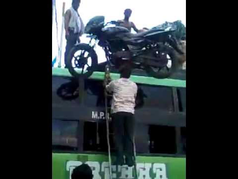Humans help Motorcycle get a ride on top of a bus - India Edition